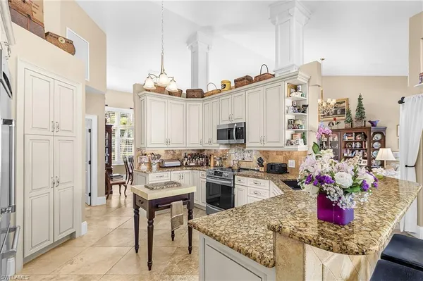 a kitchen with stainless steel appliances kitchen island granite countertop a stove and cabinets