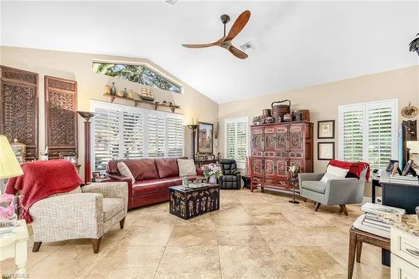 a living room with furniture and a floor to ceiling window