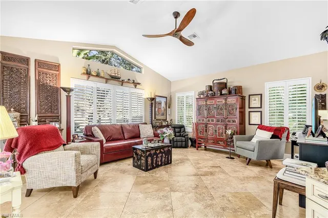 a living room with furniture and a floor to ceiling window