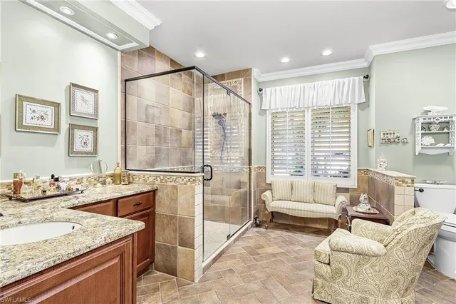 a bathroom with a granite countertop sink and a bathtub