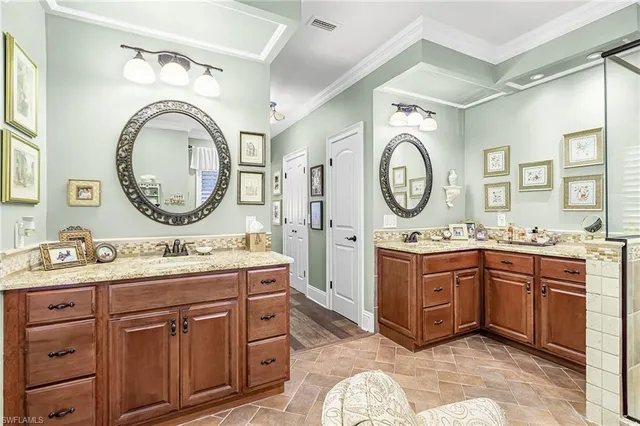 a spacious bathroom with a granite countertop double vanity sink and a mirror