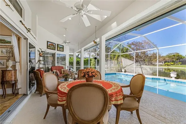 a dining room with furniture a rug and a large window