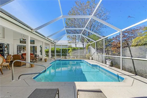a view of a swimming pool with outdoor seating