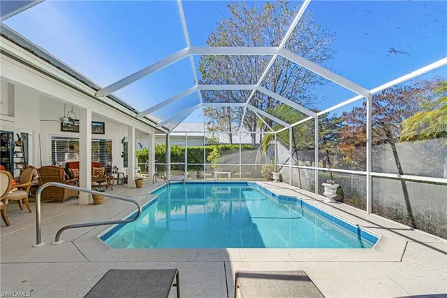 a view of a swimming pool with outdoor seating