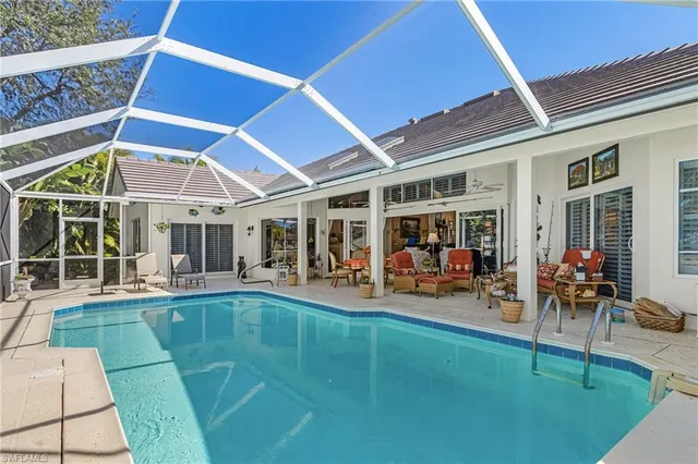 a view of a dinning room with furniture and floor to ceiling window