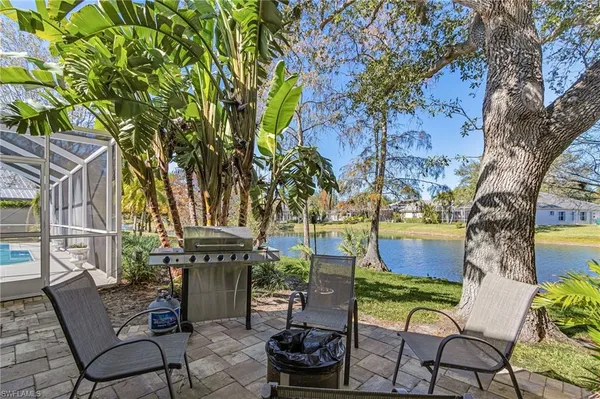 a view of a chairs and table in backyard