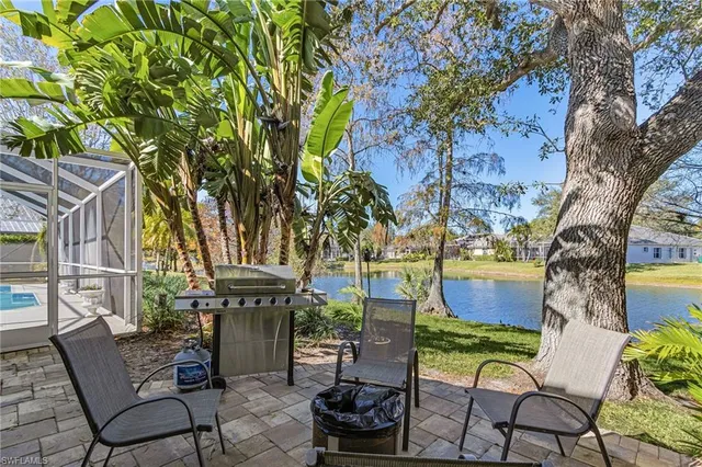 a view of a chairs and table in backyard