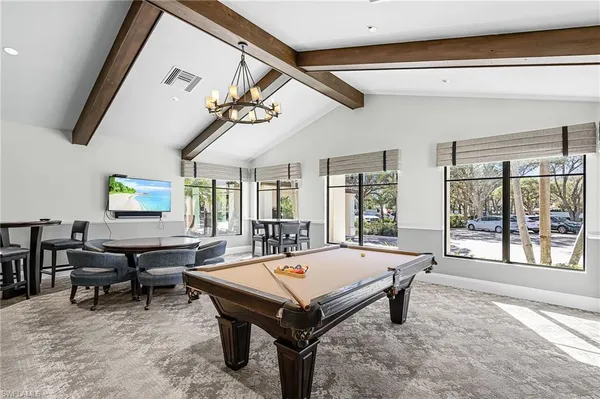 a living room with furniture a table and a large window
