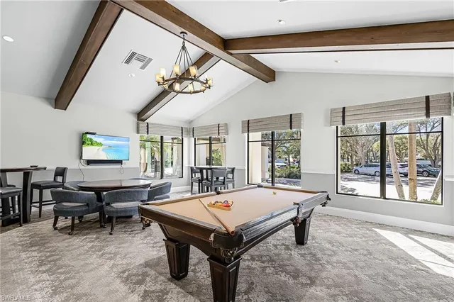 a living room with furniture a table and a large window