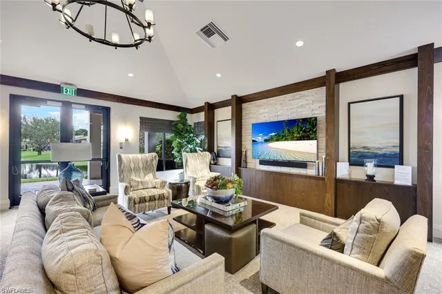 a living room with furniture ceiling fan and a large window