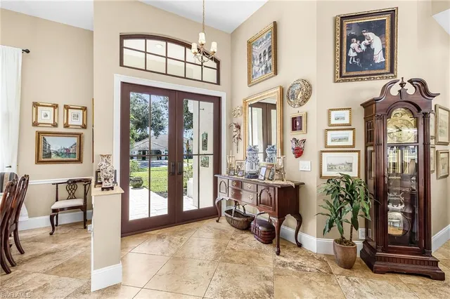 a living room with furniture and large windows