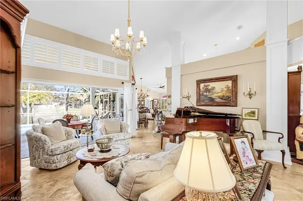 a living room with furniture or chandelier and a large window