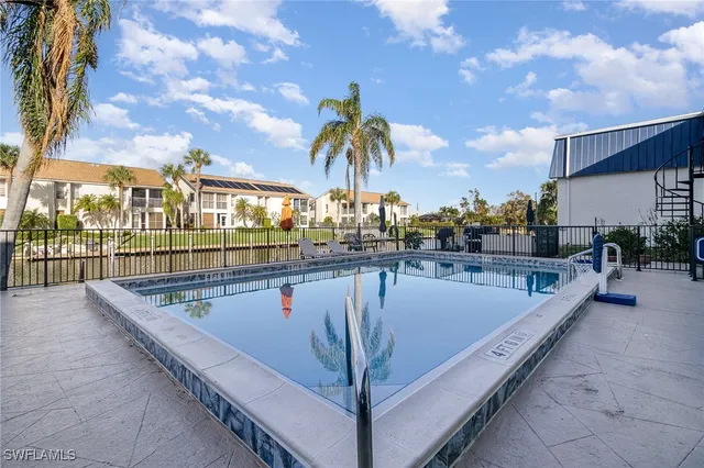 a view of swimming pool with outdoor seating