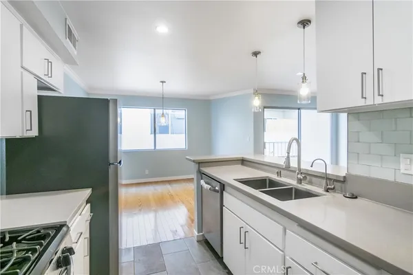 a kitchen that has a sink cabinets counter space and a sink