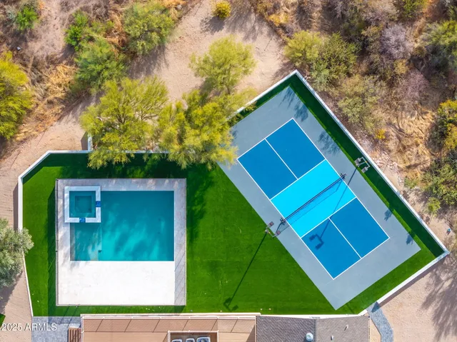 a view of a house with swimming pool and a yard