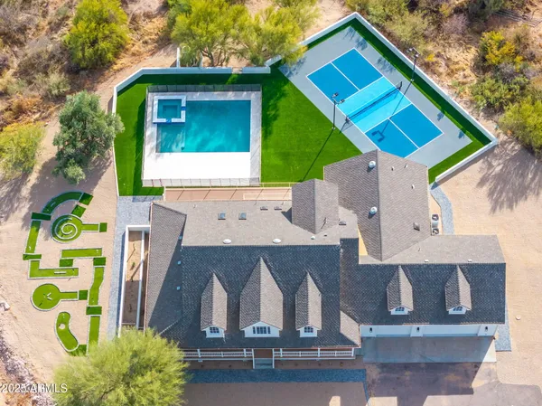 a view of swimming pool with outdoor seating and plants