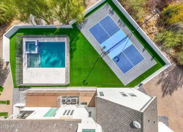 an aerial view of a house with a yard
