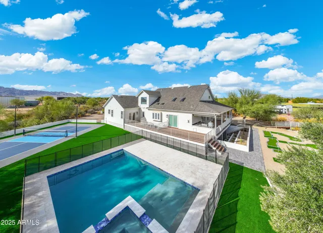 an aerial view of residential houses with outdoor space and swimming pool