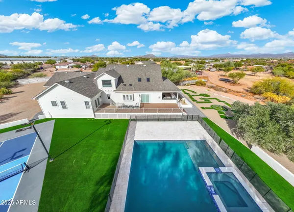 an aerial view of residential houses with outdoor space and ocean view