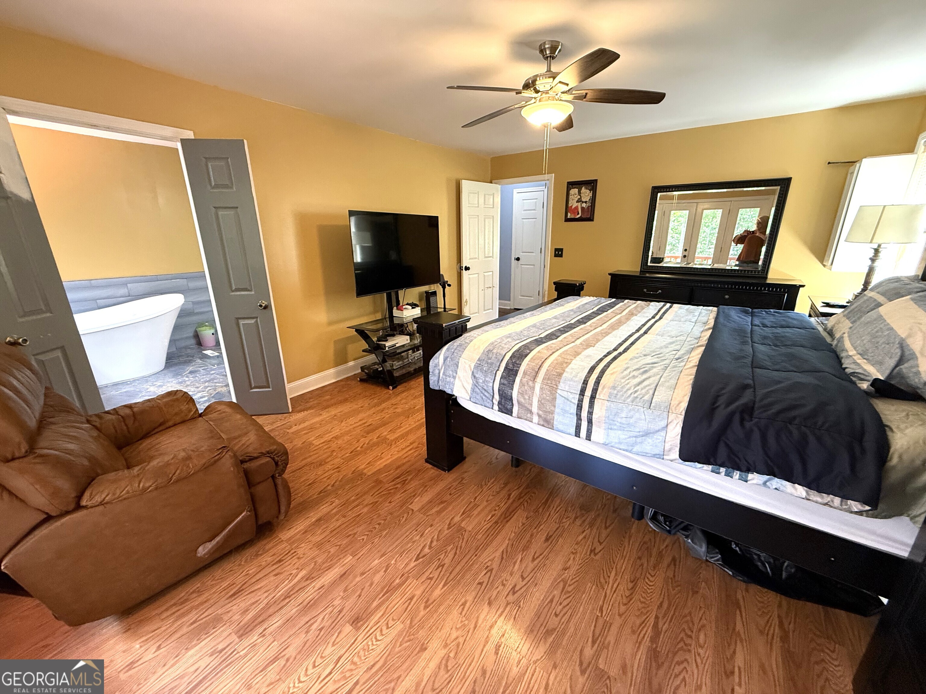 725 Musgrove Road Griffin, GA 30223 - Photo 24 of 52 a spacious bedroom with a bed and a flat screen tv