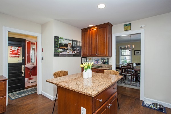 38 Dwhinda Road Newton, MA 02468 - Photo 18 of 30 a kitchen with granite countertop kitchen island wooden cabinets and stainless steel appliances