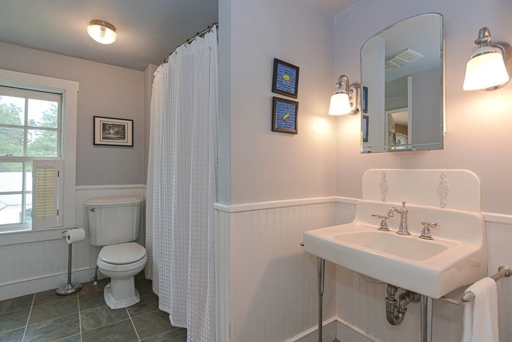 251 Gorwin Drive Holliston, MA 01746 - Photo 40 of 42 a bathroom with a sink toilet and a mirror