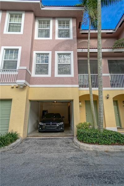 6702 West Sample Road, Unit 6702 Coral Springs, FL 33067 - Photo 2 of 8 a front view of a house with a yard and garage