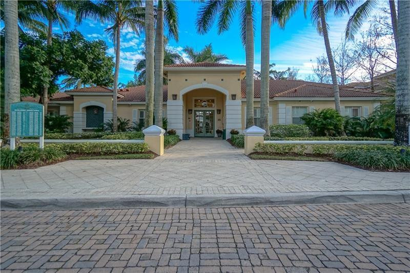 6702 West Sample Road, Unit 6702 Coral Springs, FL 33067 - Photo 5 of 8 a front view of a house with garden