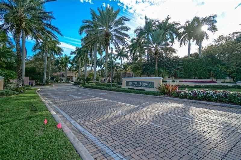 6702 West Sample Road, Unit 6702 Coral Springs, FL 33067 - Photo 6 of 8 a view of a backyard with palm trees