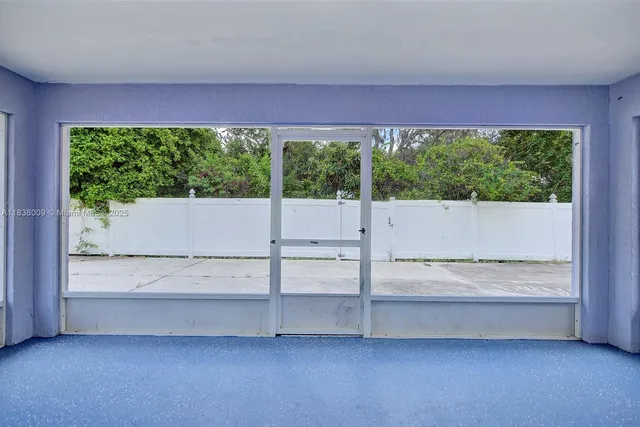 a view of room with window and a ceiling fan