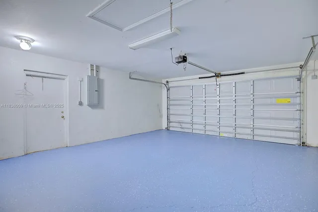 an empty room with white cabinet and mirrors