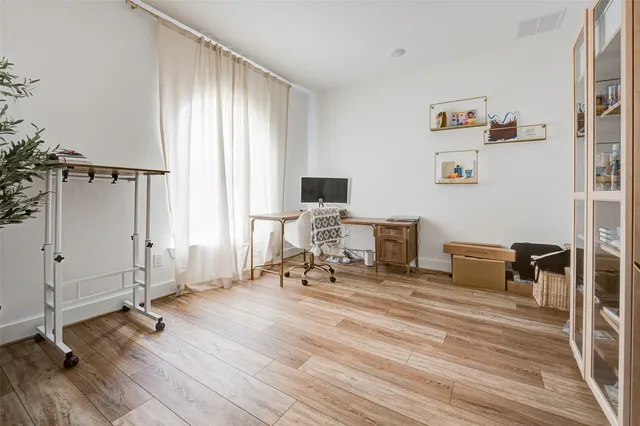 a view of a workspace with furniture and a window