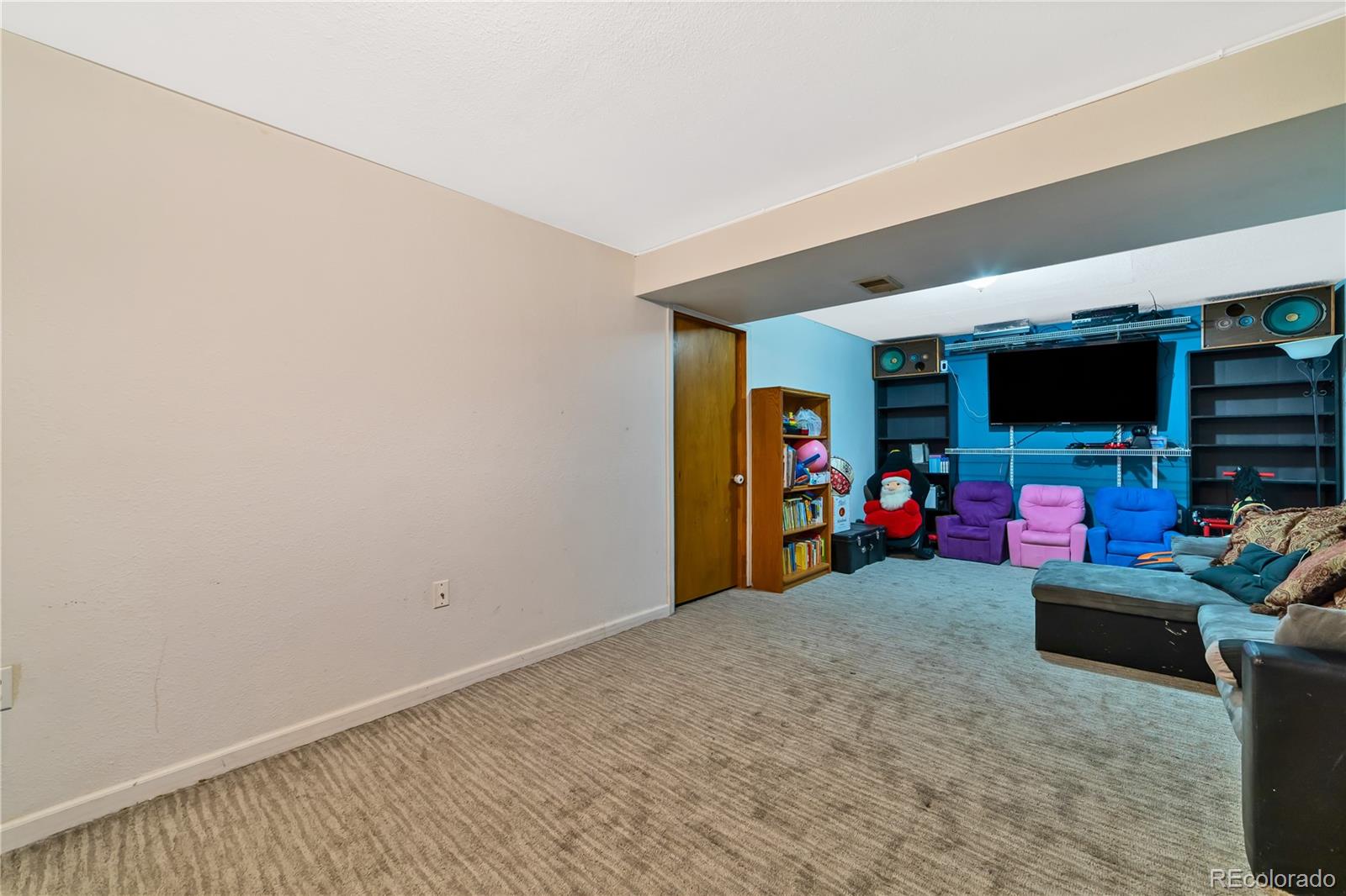 3796 South Ceylon Way Aurora, CO 80013 - Photo 14 of 16 a view of a room with gym equipment and a flat screen tv
