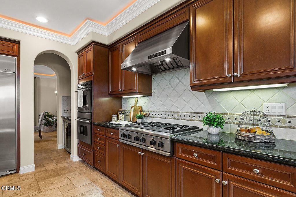 14216 Oneida Court Moorpark, CA 93021 - Photo 21 of 75 a kitchen with stainless steel appliances granite countertop a sink a stove and cabinets