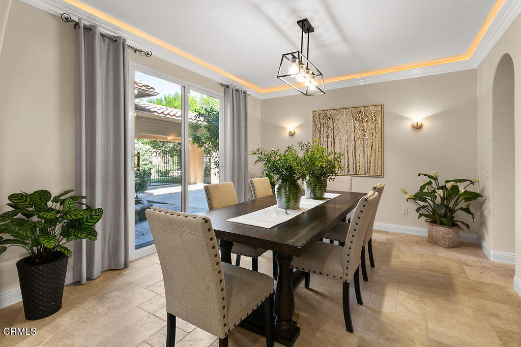 14216 Oneida Court Moorpark, CA 93021 - Photo 25 of 75 a dining room with furniture potted plants and a chandelier