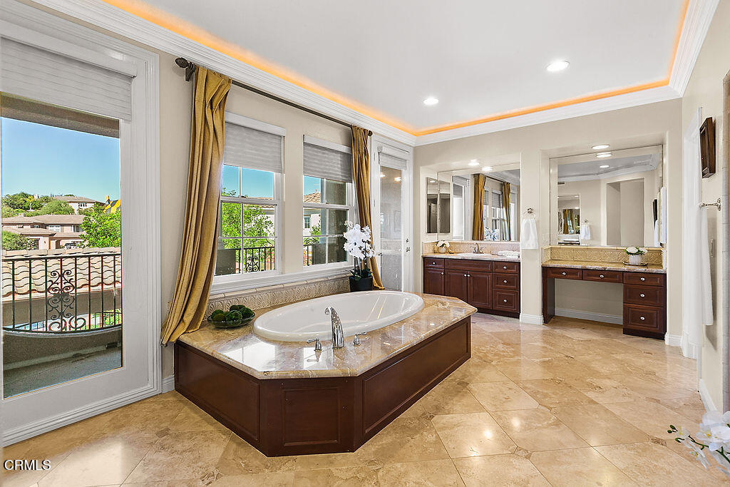 14216 Oneida Court Moorpark, CA 93021 - Photo 61 of 75 a spacious bathroom with a tub sink and mirror