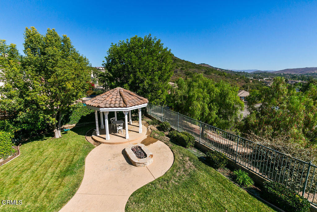 14216 Oneida Court Moorpark, CA 93021 - Photo 67 of 75 a view of a backyard with table and chairs under an umbrella