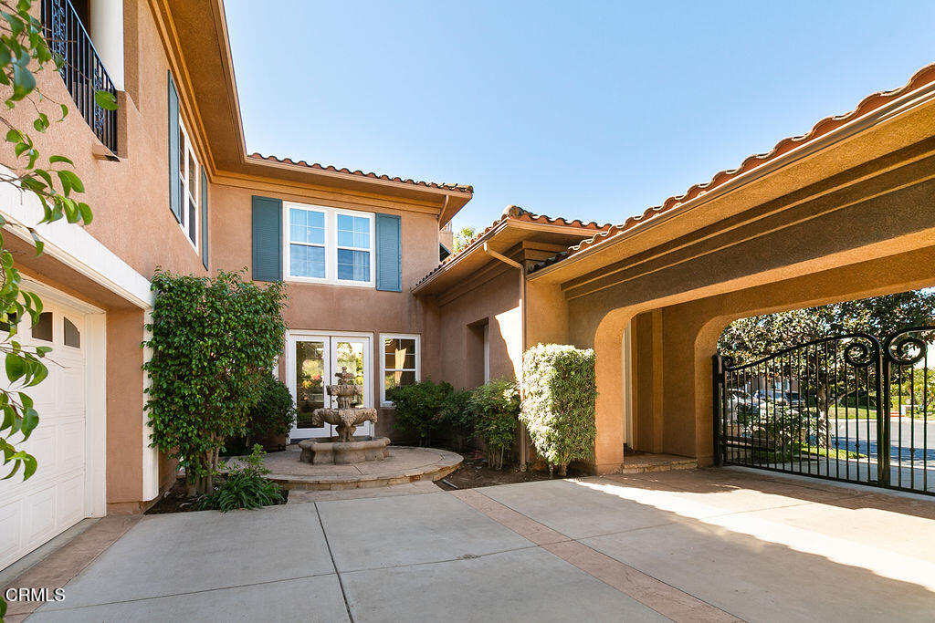 14216 Oneida Court Moorpark, CA 93021 - Photo 74 of 75 a view of a house with potted plants and a table and chairs