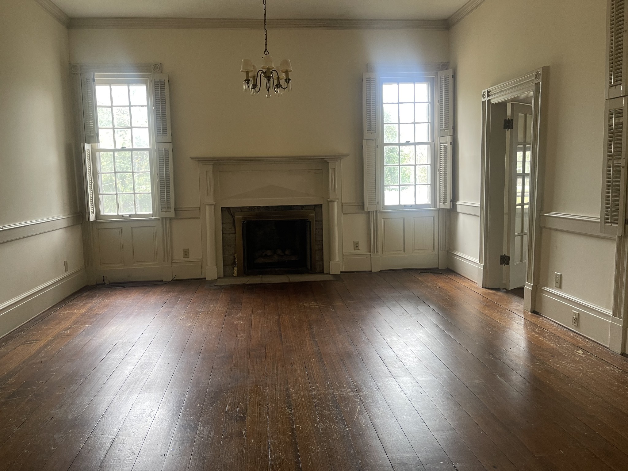 3088 Hillsboro Road Brentwood, TN 37027 - Photo 15 of 18 an empty room with wooden floor a fireplace and windows