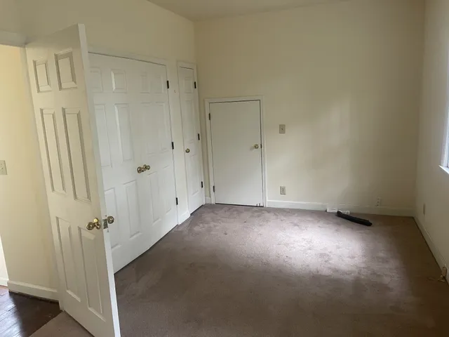 a view of a room with a wooden door