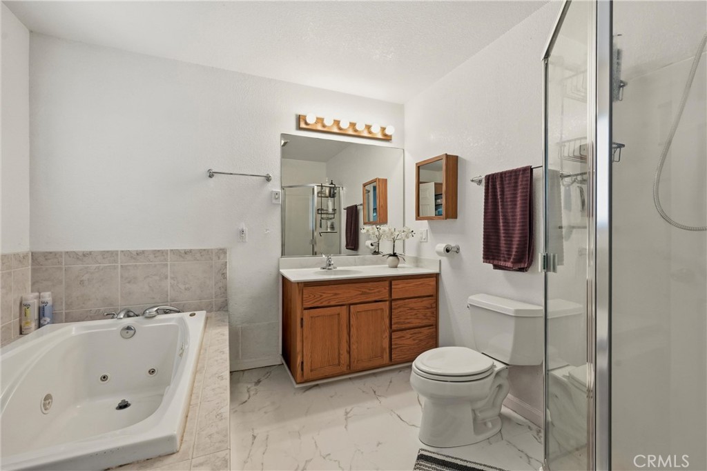 18685 Oak Grove Road Hidden Valley Lake, CA 95467 - Photo 10 of 52 a bathroom with a toilet sink and mirror