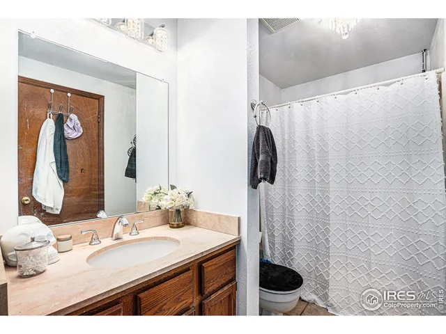 a bathroom with a sink vanity granite and a mirror
