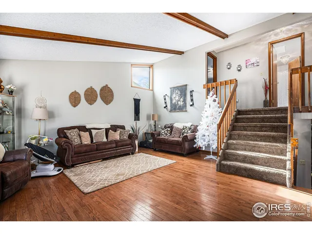 a view of a bedroom with stairs and a couch