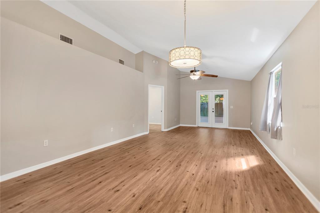 3600 Raintree Terrace Lakeland, FL 33803 - Photo 11 of 22 a view of an empty room with wooden floor and a window