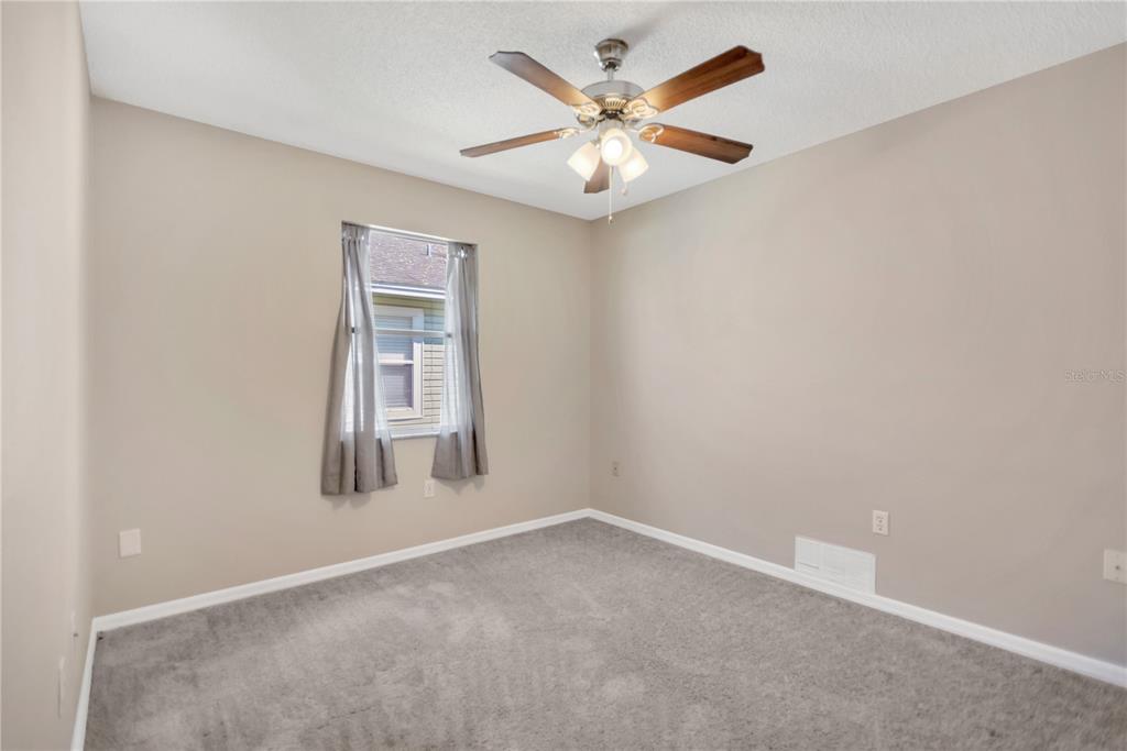 3600 Raintree Terrace Lakeland, FL 33803 - Photo 15 of 22 an empty room with windows and fan
