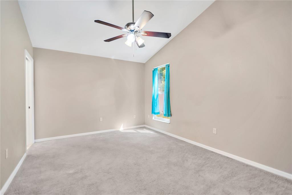 3600 Raintree Terrace Lakeland, FL 33803 - Photo 19 of 22 an empty room with a window and a fan