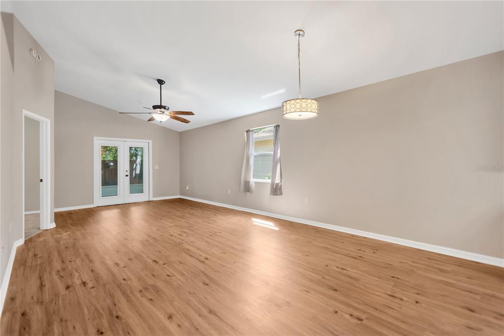 3600 Raintree Terrace Lakeland, FL 33803 - Photo 10 of 22 a view of a room with wooden floor and chandelier