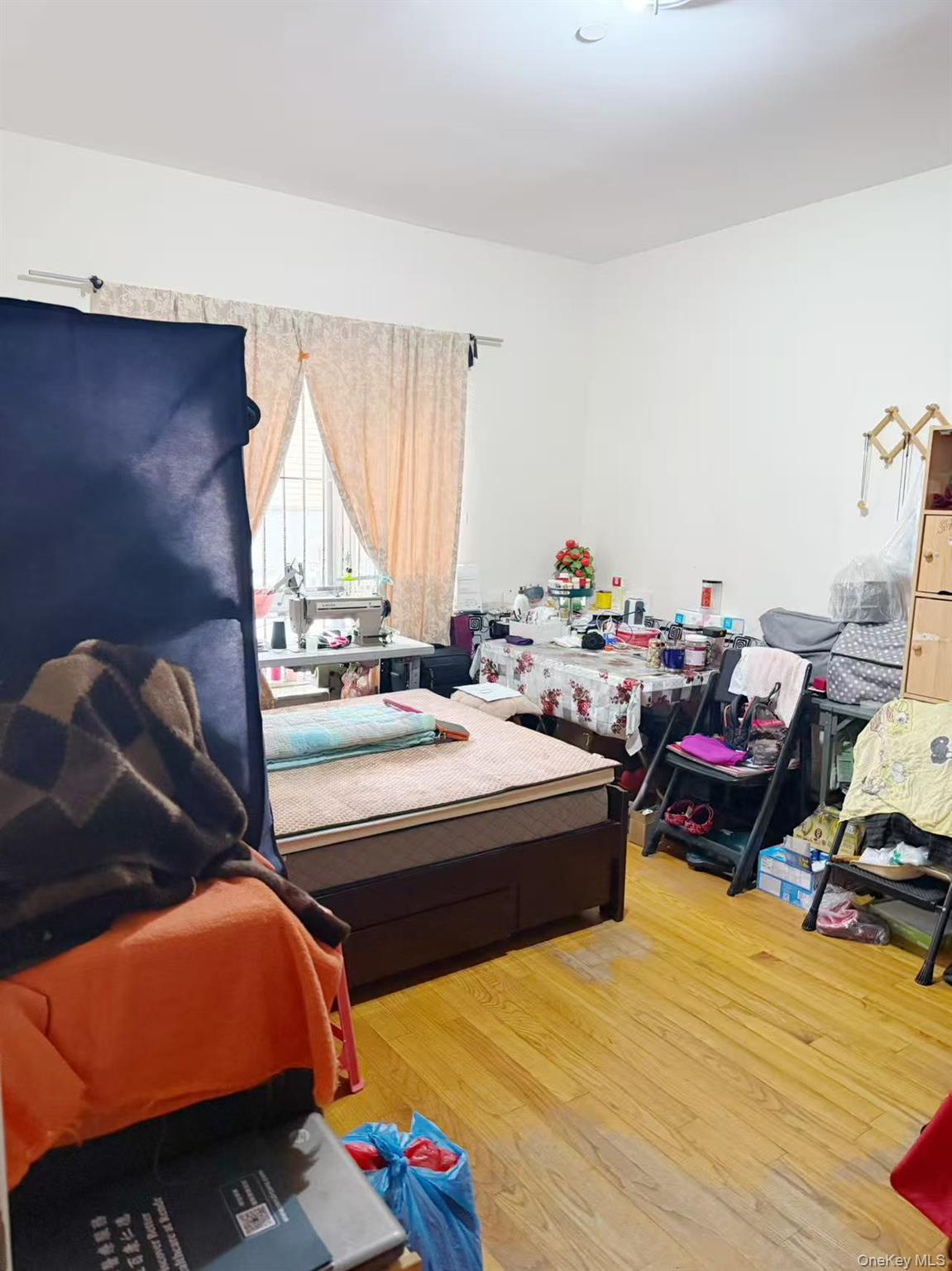 8510 Elmhurst Avenue, Unit 1C Queens, NY 11373 - Photo 9 of 9 a bed room with a bed and a chair
