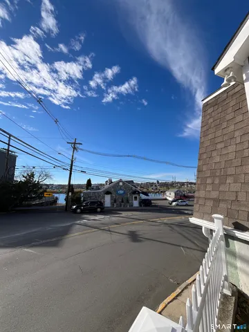 a view of water heater and a car parked in garage