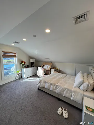 a bedroom with bed and a window